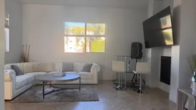 a living room with a white couch and a tv at LA Dream Gem - Beautiful Home with Spa in Los Angeles