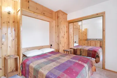 a bedroom with two beds and wooden walls at The Alps Lodge #2142 by Big Bear Vacations in Big Bear Lake