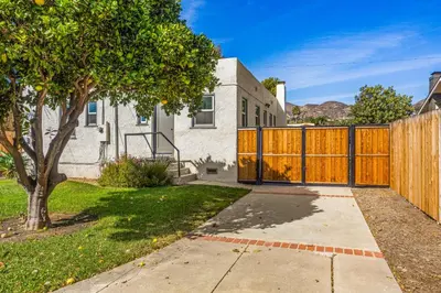 a wooden fence in front of a house at Mid-Town Escape in Ventura