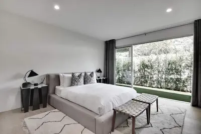 a bedroom with a large bed and a large window at Vista Modern in Los Angeles