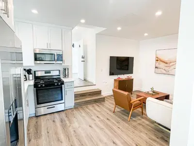 a kitchen and living room with a stove and a table at Cozy Habitat in Los Angeles