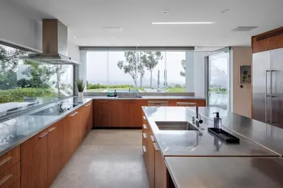 a large kitchen with wooden cabinets and a large window at Vue Modern in Los Angeles
