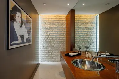 a bathroom with a sink and a painting on the wall at Vue Modern in Los Angeles