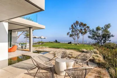 a patio with chairs and a table with a view at Vue Modern in Los Angeles