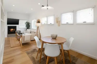 a living room with a table and chairs and a couch at Exclusive 2BD 3BA with Balcony in Los Angeles
