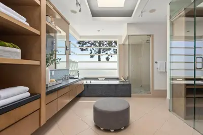 a bathroom with a tub and a stool in the middle at Trousdale Grand in Los Angeles