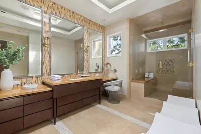a bathroom with a sink and a toilet and a shower at Trousdale Grand in Los Angeles