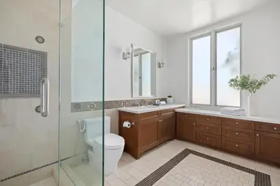 a bathroom with a toilet and a glass shower at Trousdale Grand in Los Angeles