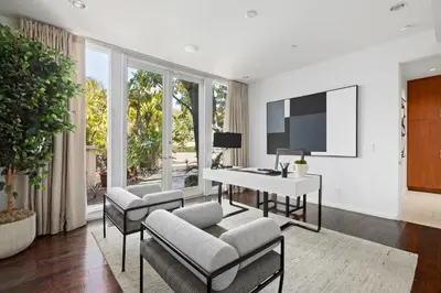 a living room with a desk and a tv at Trousdale Grand in Los Angeles