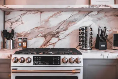 a kitchen with a marble counter top with a stove at @ Marbella Lane - Vibrant & Chic Designer Home in Fullerton