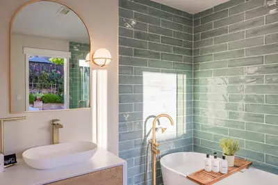 a bathroom with a tub and a sink and a mirror at @ Marbella Lane - Vibrant & Chic Designer Home in Fullerton