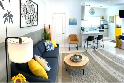 a living room with a blue couch and a table at King Garden Suite - 10 mins to Beach and LAX in Gardena