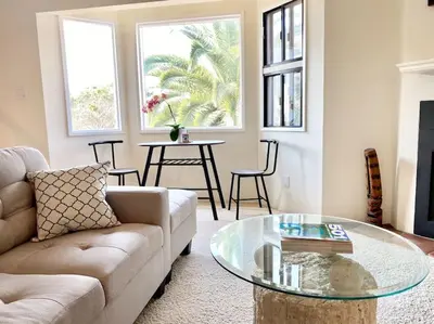 a living room with a couch and a glass table at Modern & Cozy Gem ~ Walk to the Beach ~ Queen Beds in Carpinteria