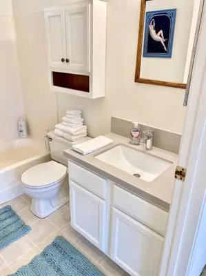 a white bathroom with a sink and a toilet at Modern & Cozy Gem ~ Walk to the Beach ~ Queen Beds in Carpinteria