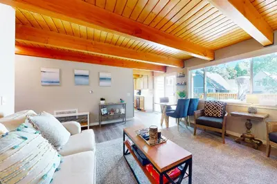 a living room with a white couch and a table at Hemlock Haven in Lake Arrowhead