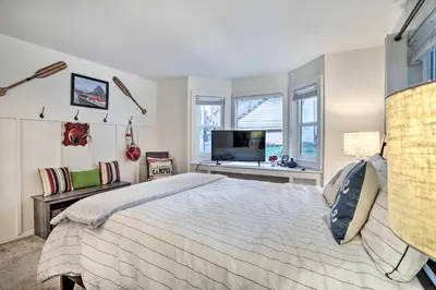 a bedroom with a bed and a flat screen tv at Lovely Lake Arrowhead Cabin with Furnished Deck in Lake Arrowhead