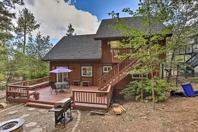 a large wooden house with a large deck at Lovely Lake Arrowhead Cabin with Furnished Deck in Lake Arrowhead