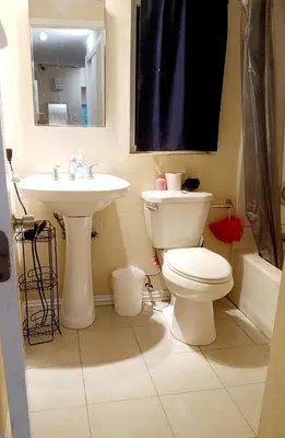 a bathroom with a toilet and a sink at We are in this together in Santa Ana