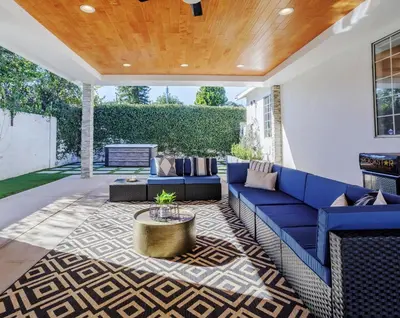 a patio with a blue couch and a table at New 5 bed w/hot tub close to Universal sleeps 12 in Los Angeles