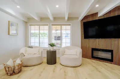 a living room with two chairs and a flat screen tv at New 5 bed w/hot tub close to Universal sleeps 12 in Los Angeles