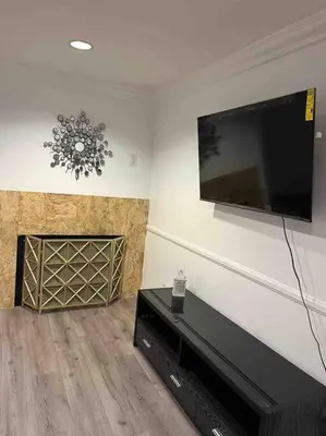 a living room with a flat screen tv on the wall at Woodland Hills 3 bedroom w/ pool and spa in Los Angeles