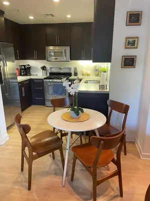 a kitchen with a table and chairs and a kitchen with a stove at Super-Cute 2/2 apartment in Santa Monica with free parking in Los Angeles