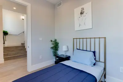 a bedroom with a blue bed and a hallway at Modern 5 Bedroom Masterpiece With Rooftop Deck in Los Angeles