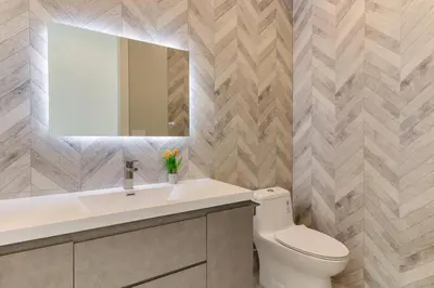a bathroom with a toilet and a sink and a mirror at Modern 5 Bedroom Masterpiece With Rooftop Deck in Los Angeles