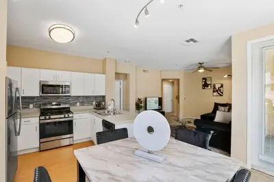 a kitchen and living room with a table with a bowl on it at Luxury 2BR/2BA!5Min to Disney! Angelstadium! HondaCenter. in Anaheim