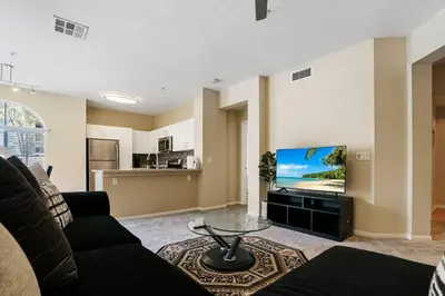 a living room with a couch and a flat screen tv at Luxury 2BR/2BA!5Min to Disney! Angelstadium! HondaCenter. in Anaheim