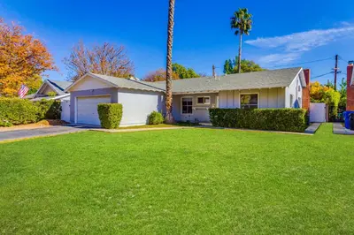 a house with a large lawn in front of it at 4 Bedroom West Hills Charmer with Pool in West Hills