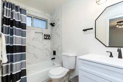 a white bathroom with a sink and a toilet at Newly Remodeled 5B4B 2 mile from the Rose Parade in Pasadena