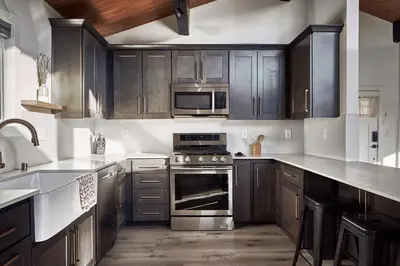 a kitchen with wooden cabinets and a stove top oven at Vista Haus in Crestline