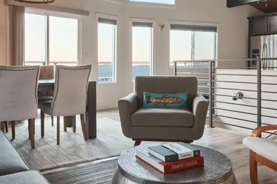 a living room with a chair and a table at Vista Haus in Crestline
