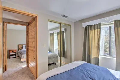a bedroom with a bed and a mirror at Idyllic Frazier Park Cabin Views, Pool Table in Frazier Park