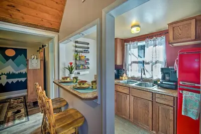 a kitchen with a sink and a red refrigerator at Running Springs Cabin with Deck and Forest Views in Running Springs