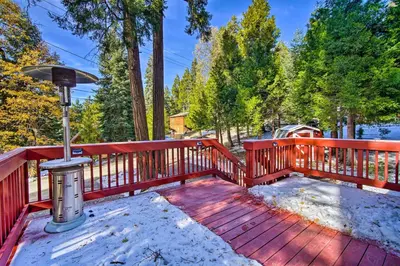 a wooden deck with snow on it at Running Springs Cabin with Deck and Forest Views in Running Springs
