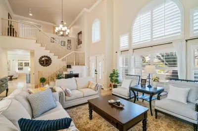 a living room with white furniture and a staircase at @ Marbella Lane - Captivating Home in Rowland Hts in Rowland Heights