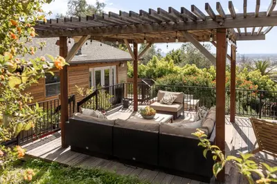 a patio with a couch under a pergola at Hollywood Hideaway in Los Angeles