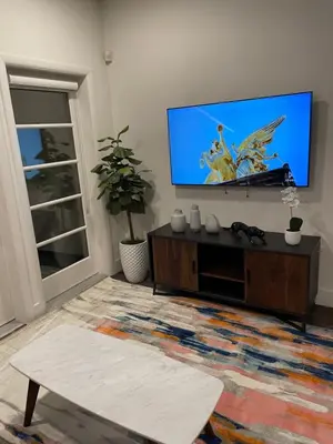 a living room with a flat screen tv on a wall at Lovely 2/2 apartment in heart of Santa Monica with free parking in Los Angeles
