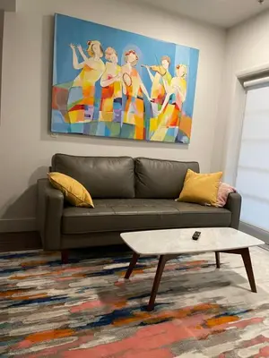 a living room with a couch and a painting at Lovely 2/2 apartment in heart of Santa Monica with free parking in Los Angeles