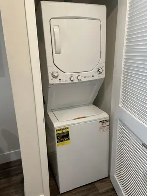 a small white washer and dryer in a room at Lovely 2/2 apartment in heart of Santa Monica with free parking in Los Angeles