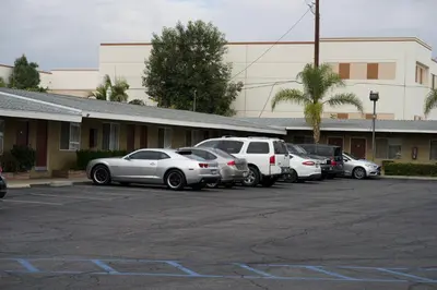 a group of cars parked in a parking lot at Sands Motel by Ontario Airport & Toyota Arena in Ontario