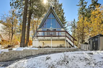 a house with a gambrel roof with a glass pyramid at Cozy A-Frame with Hot Tub Near Arrowbear Lake! in Running Springs