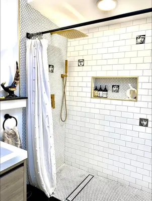 a bathroom with a shower with white tiles at Romantic cottage with amazing garden in Glendale