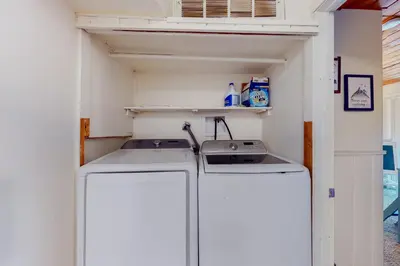 a small laundry room with a washer and dryer at The Retreat on Wabash Lane in Lake Arrowhead
