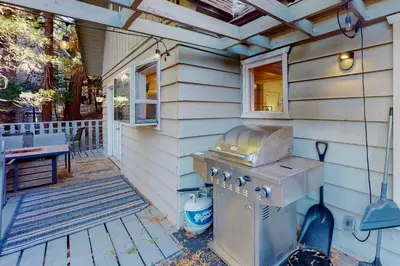a outdoor kitchen with a grill on a house at The Retreat on Wabash Lane in Lake Arrowhead