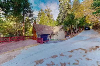 a house with a red fence on a road at The Retreat on Wabash Lane in Lake Arrowhead