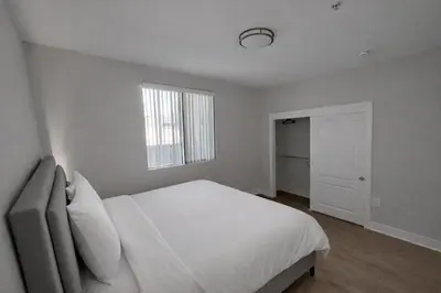 a white bedroom with a bed and a window at Luxury 2 Bedrooms 2 Bathrooms With Pool and Gym in Los Angeles