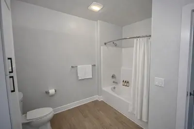 a white bathroom with a shower and a toilet at Luxury 2 Bedrooms 2 Bathrooms With Pool and Gym in Los Angeles